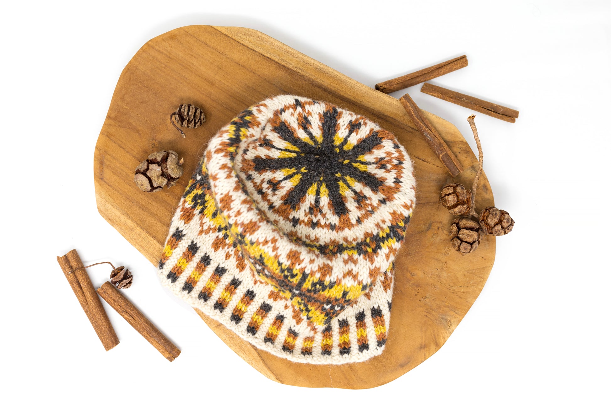 A crown of a white, orange, black and yellow Fair Isle hat