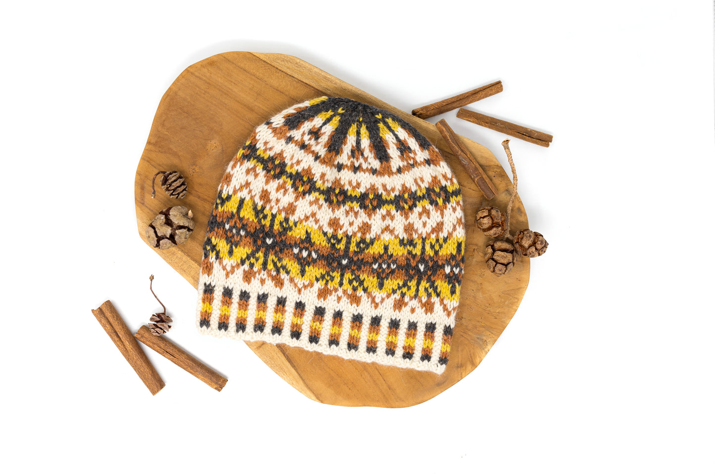 Front view of a white, orange, yellow and black Fair Isle beanie hat