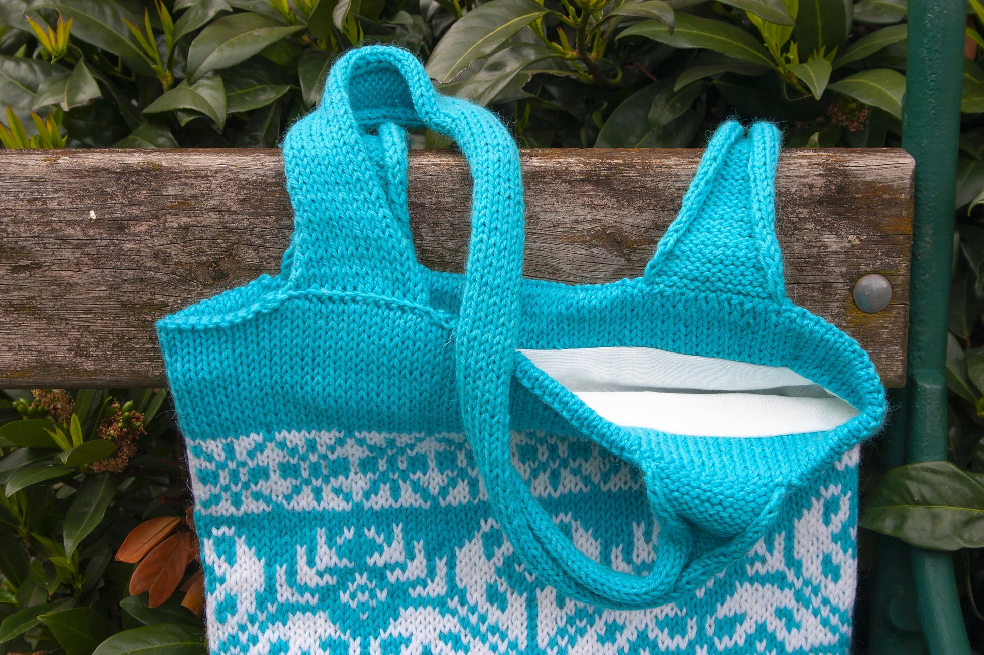 Details of a handles of turquoise and white Snowflake Selbu hand-knitted tote bag
