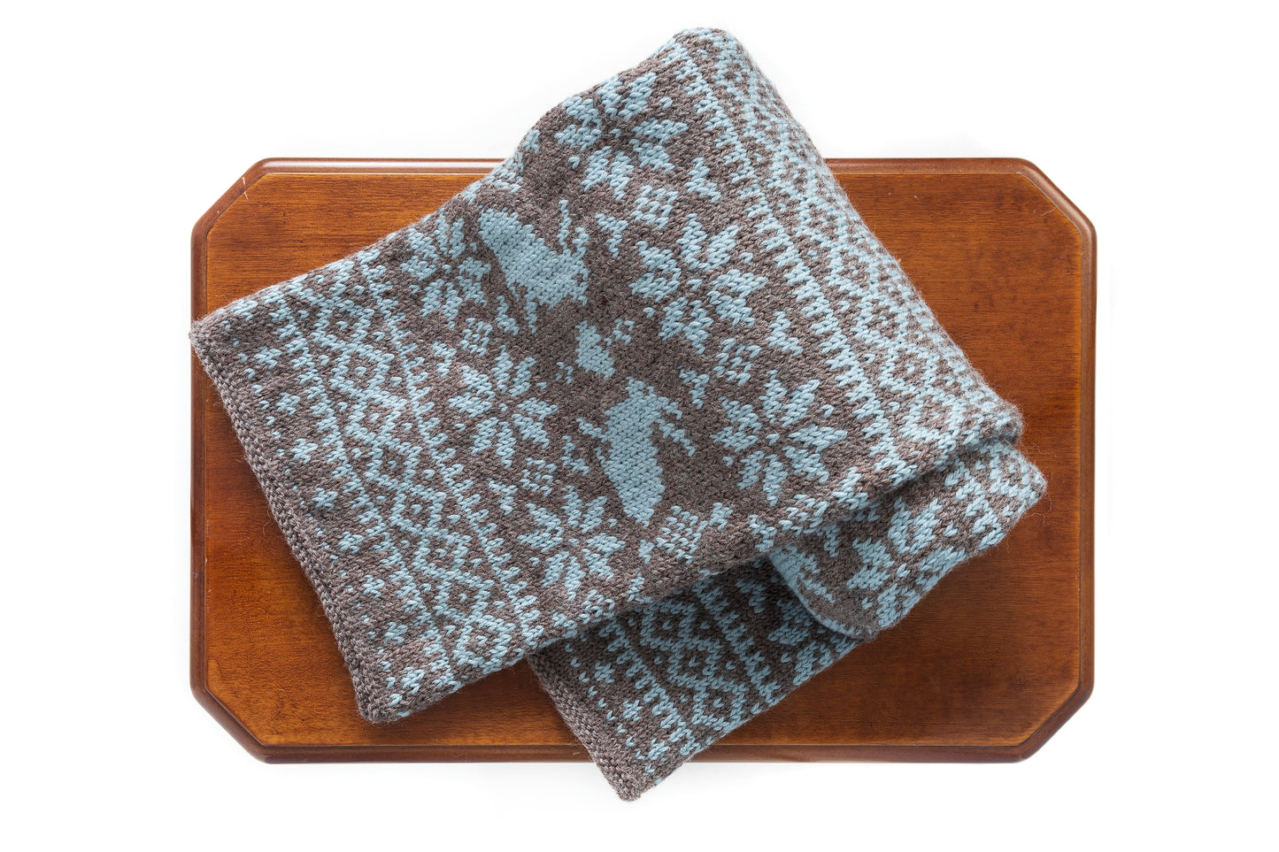 Brown and grey blue wool hand-knitted long Fair Isle scarf in Bunny Rabbit pattern folded on a table