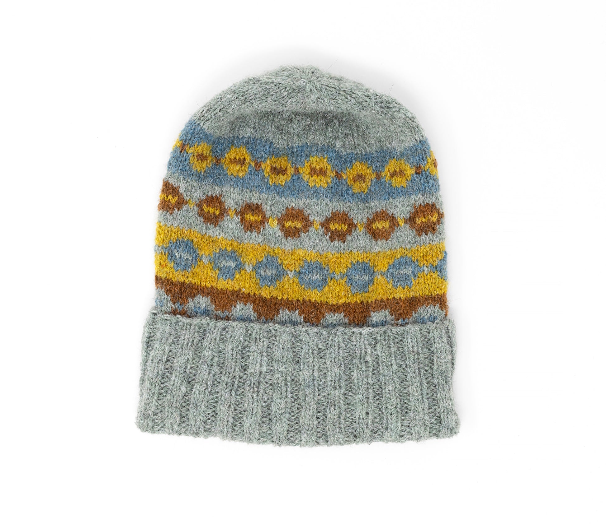 Grey, brown, yellow and blue alpaca wool hand-knitted Fair Isle hat with folded brim on a white background
