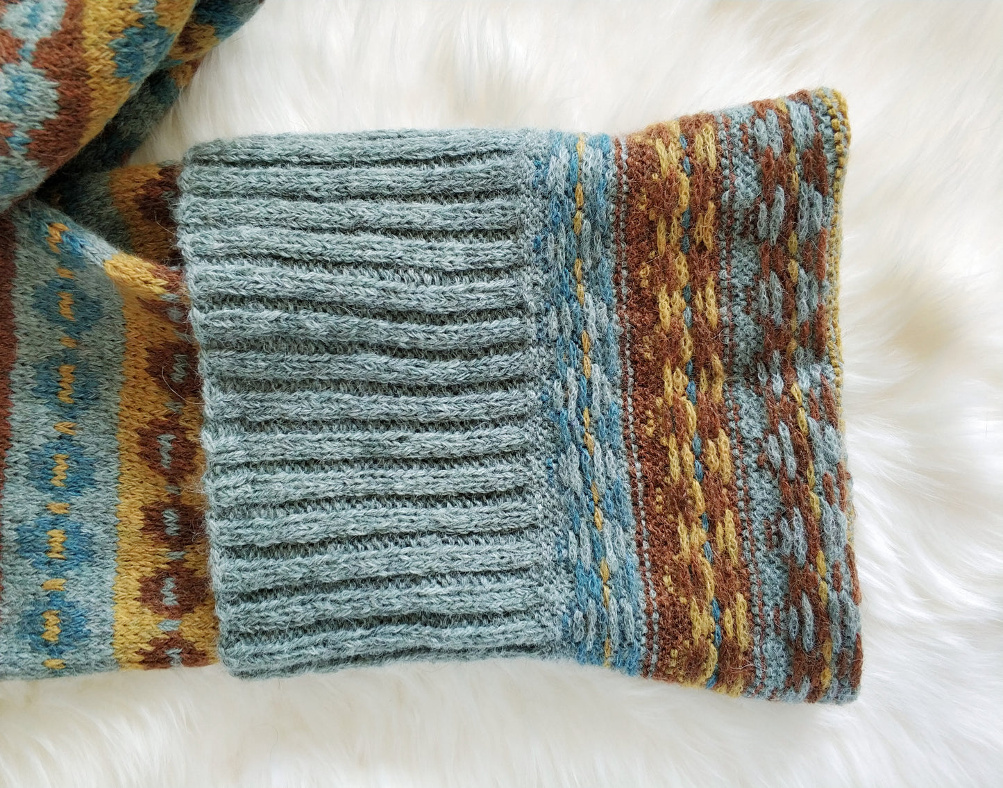 close up for grey blue, yellow and brown wool long hand-knitted Fair Isle scarf