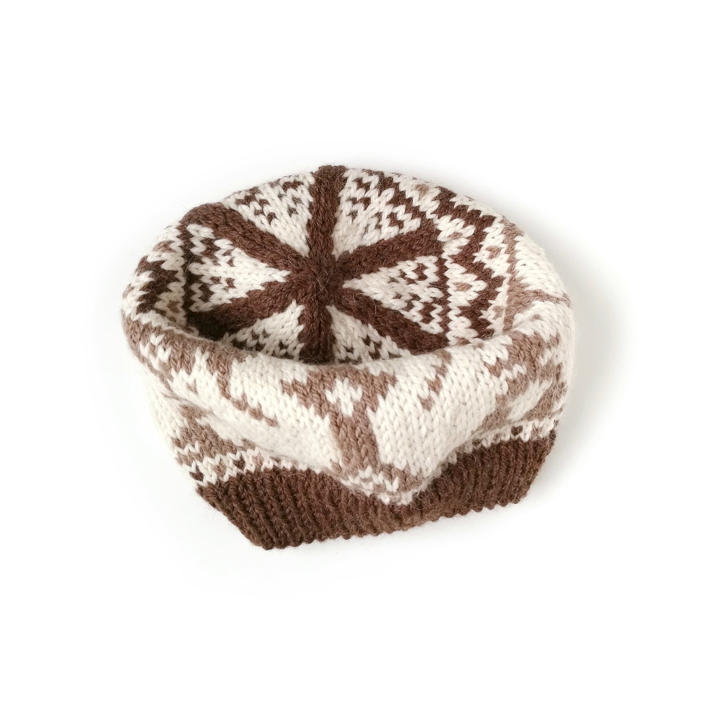Brown and white hand-knitted Fair Isle beanie hat with a squirrel motif on a white background