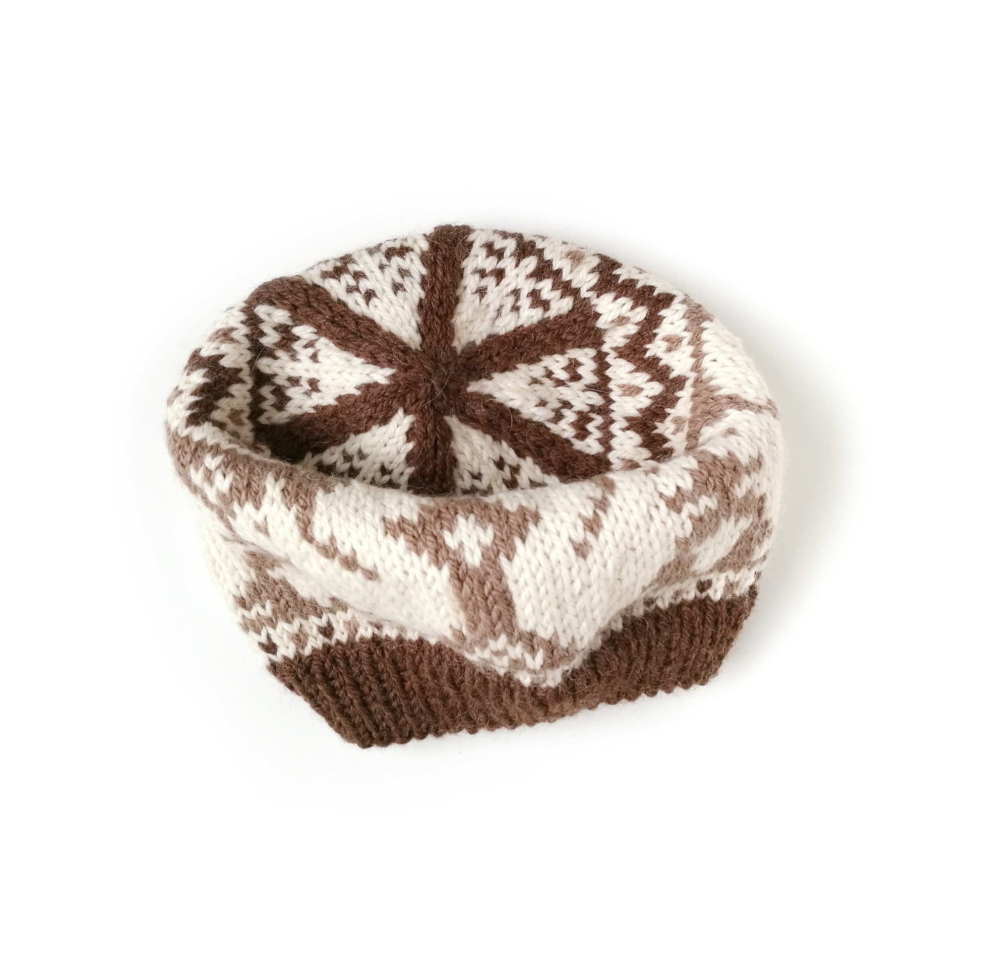 Brown and white hand-knitted Fair Isle beanie hat with a squirrel motif on a white background