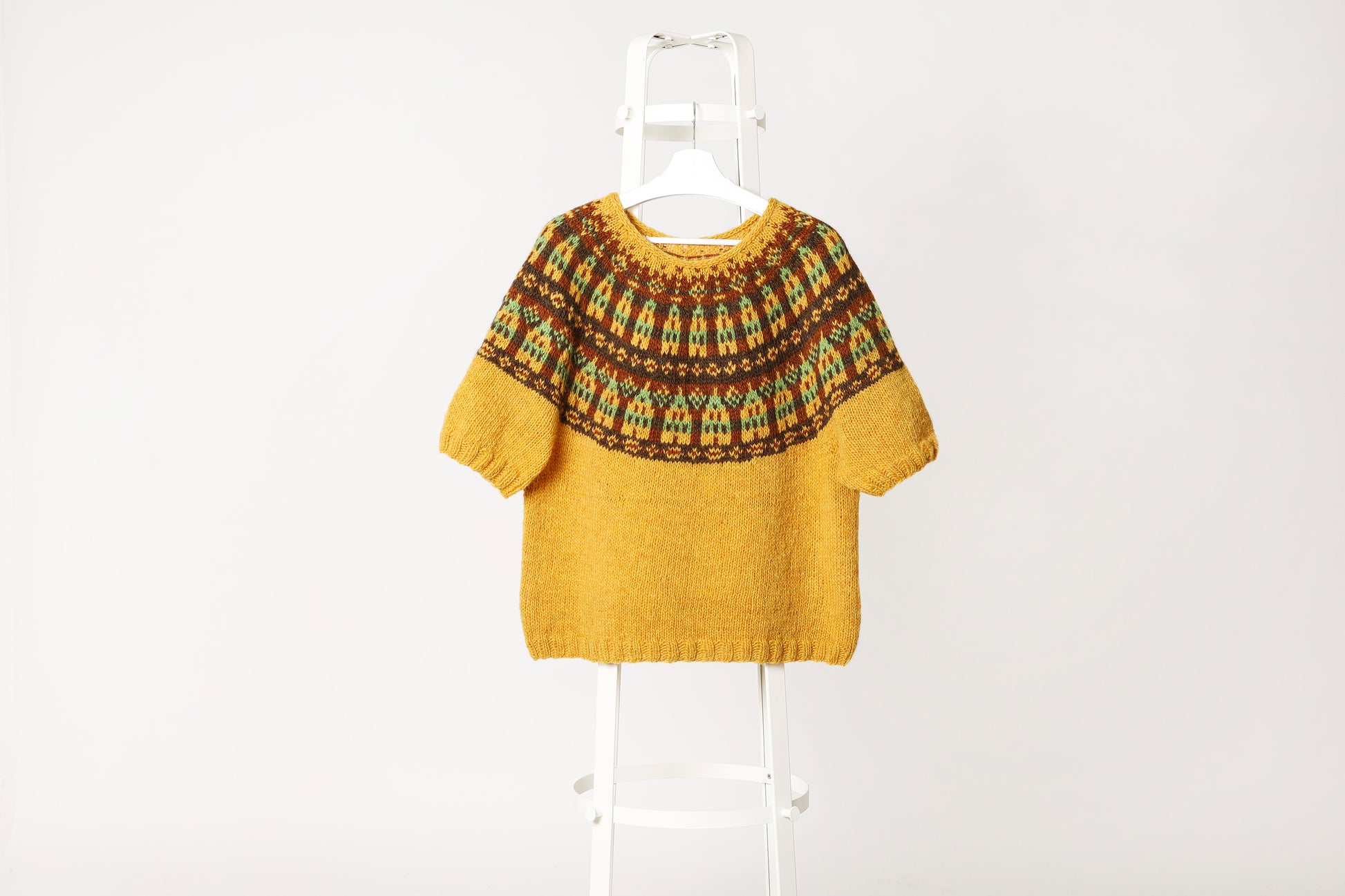 Hand-knitted Stortorget icelandic lopapeysa sweater with patterned yoke on a white background