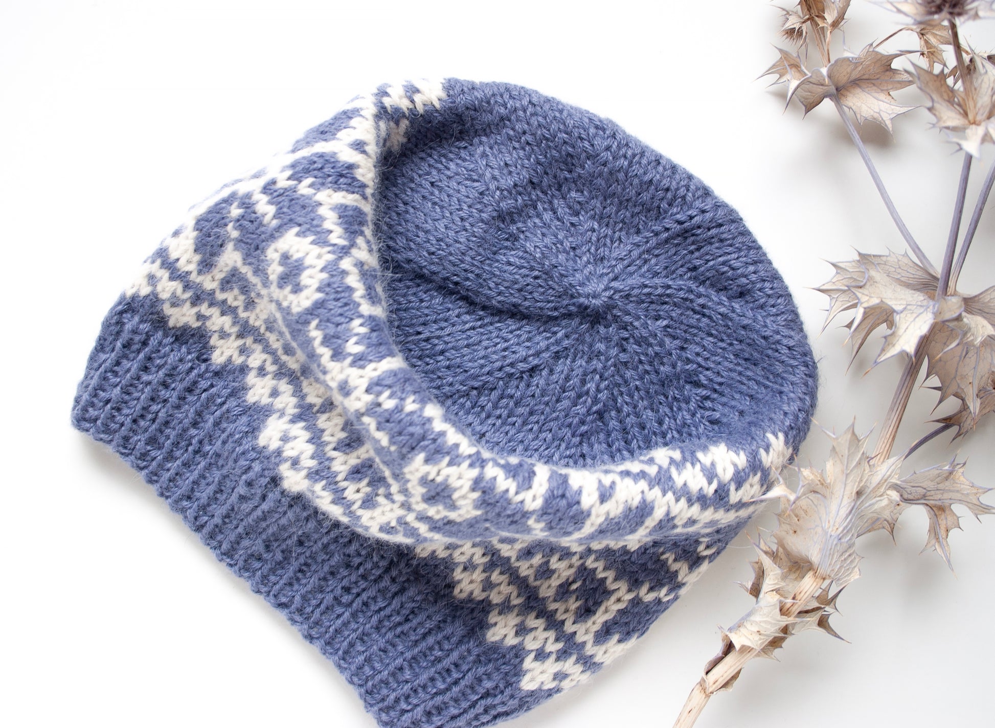 blue and white alpaca wool hand-knitted Fair Isle beanie hat in snowflake knitting pattern