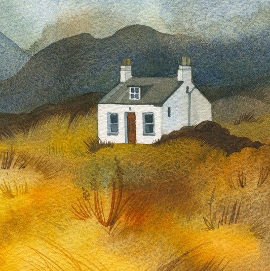 Small white house in a scenic field landscape with mountains and grass.
