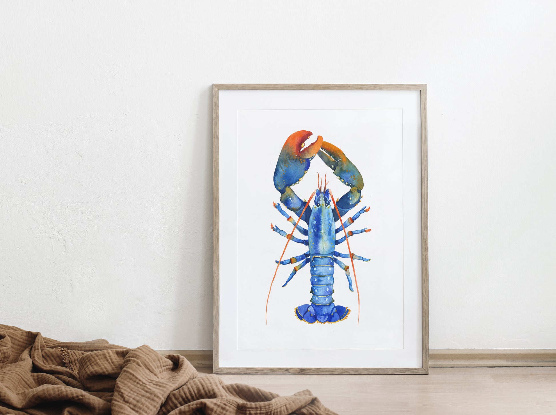 Large framed Blue European lobster watercolor art print on a floor