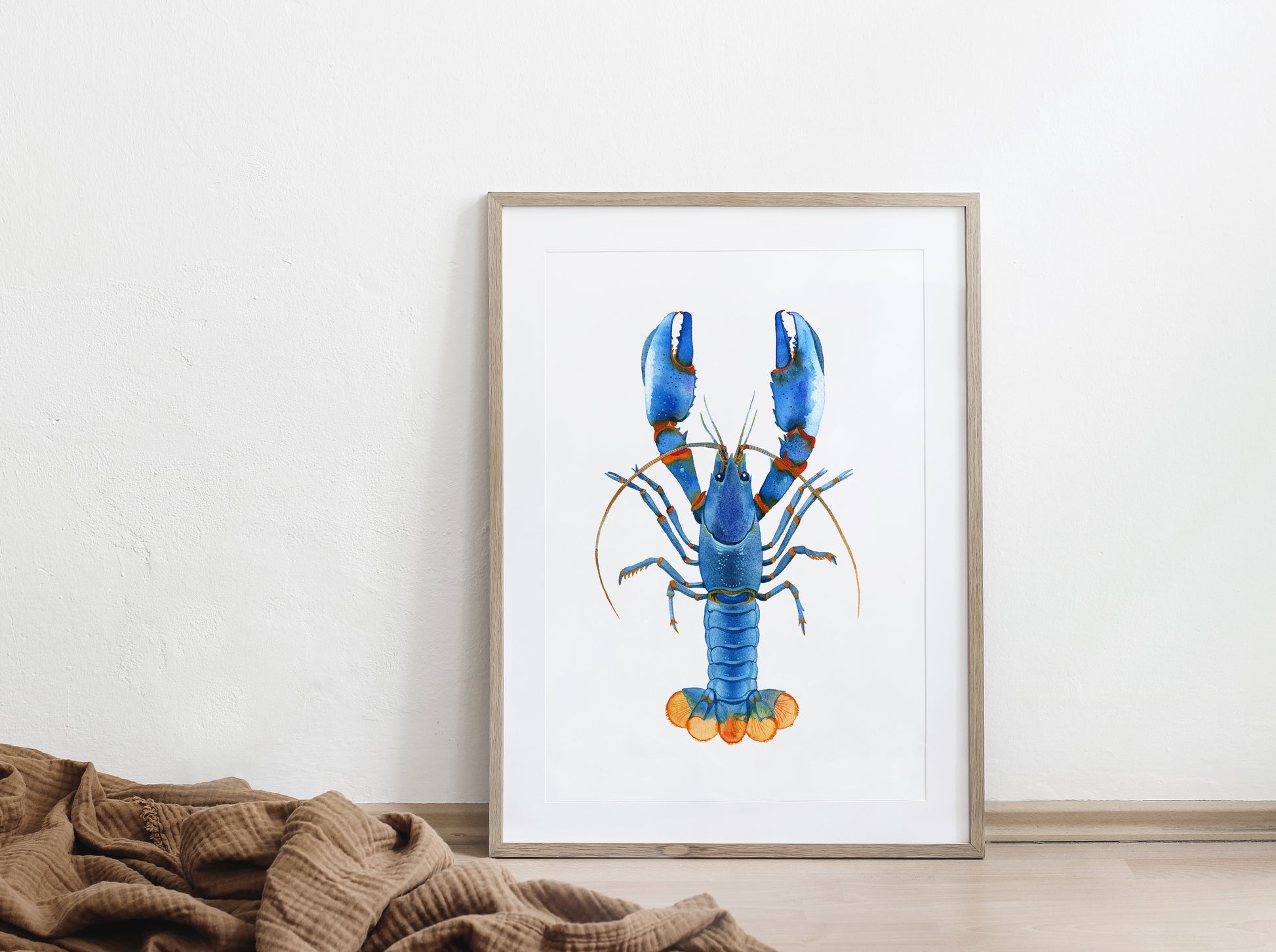 Framed Blue Kong Zebra Crayfish watercolor painting displayed on a floor