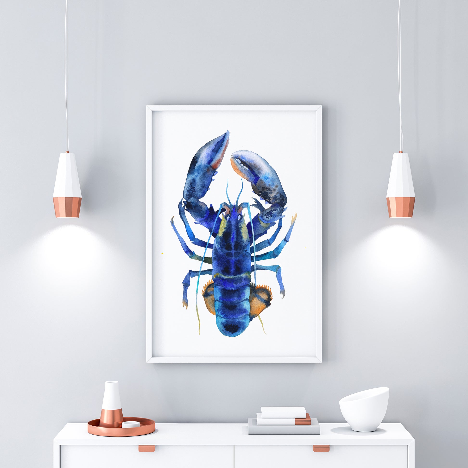 Framed blue lobster watercolor art print on a white wall