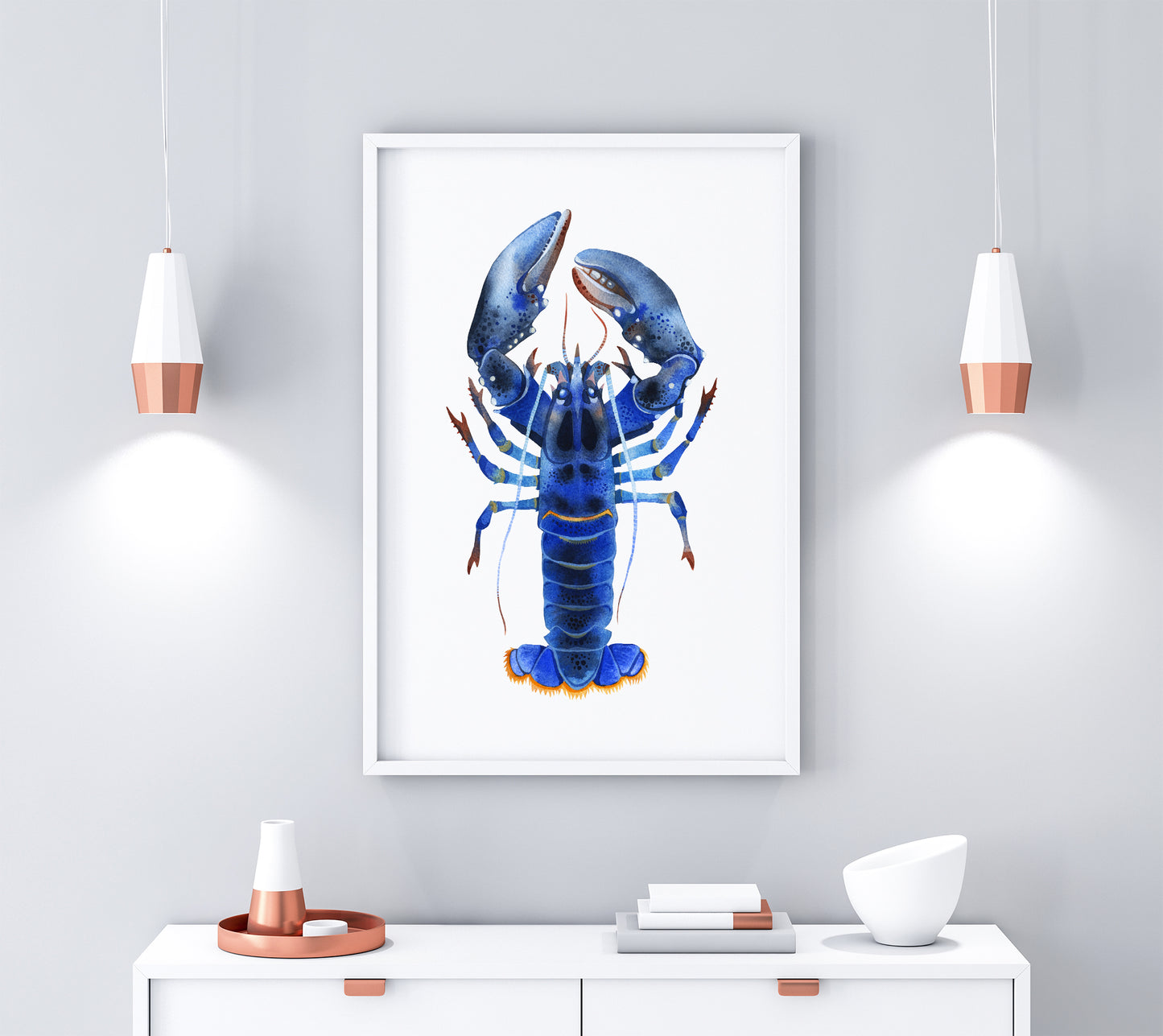 Blue Lobster watercolor print in a white frame, displayed on a gray wall