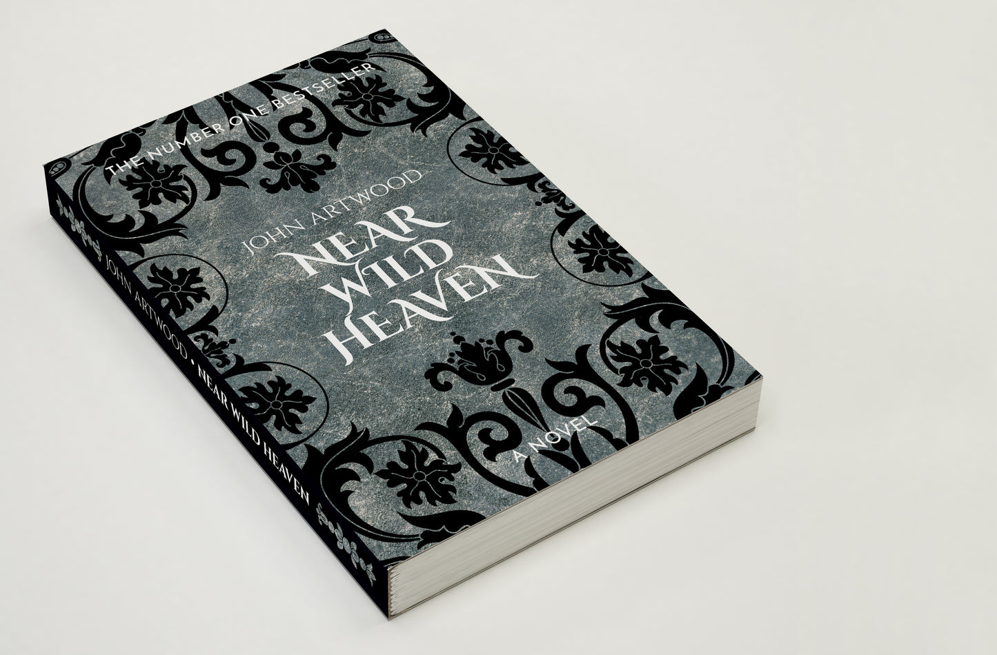 Close-up of a book with black baroque ornament on a silver background on its cover