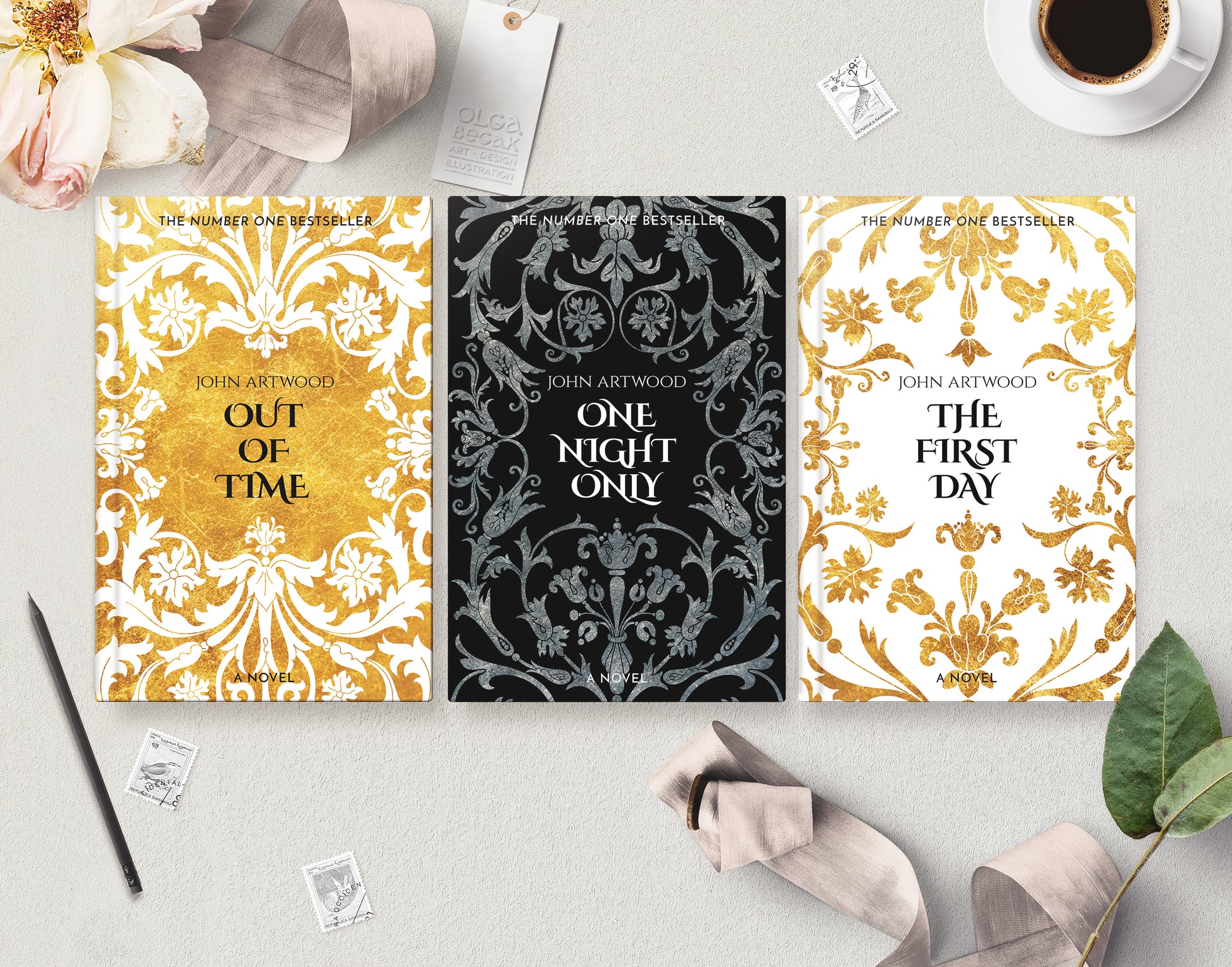 Three premade book series cover templates are arranged in a styled flat lay on a light gray surface, surrounded by decorative props including a coffee cup, flowers, stamps, a pen, and ribbons.