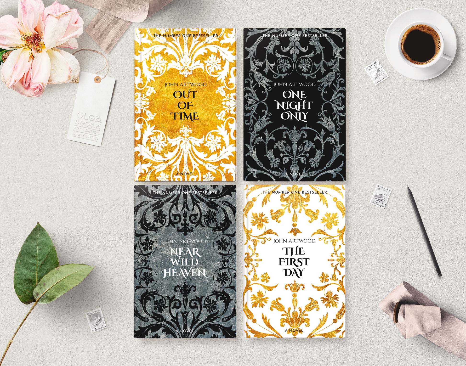 Four book series covers with baroque ornaments in gold, black, silver and white, layng flat on a gray surface accompanied with a cup of coffee