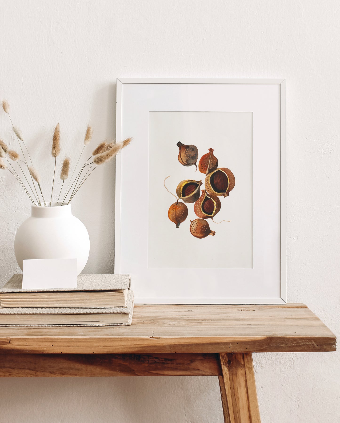 A framed botanical art print of a watercolor study of bottlebrush buckeye seeds