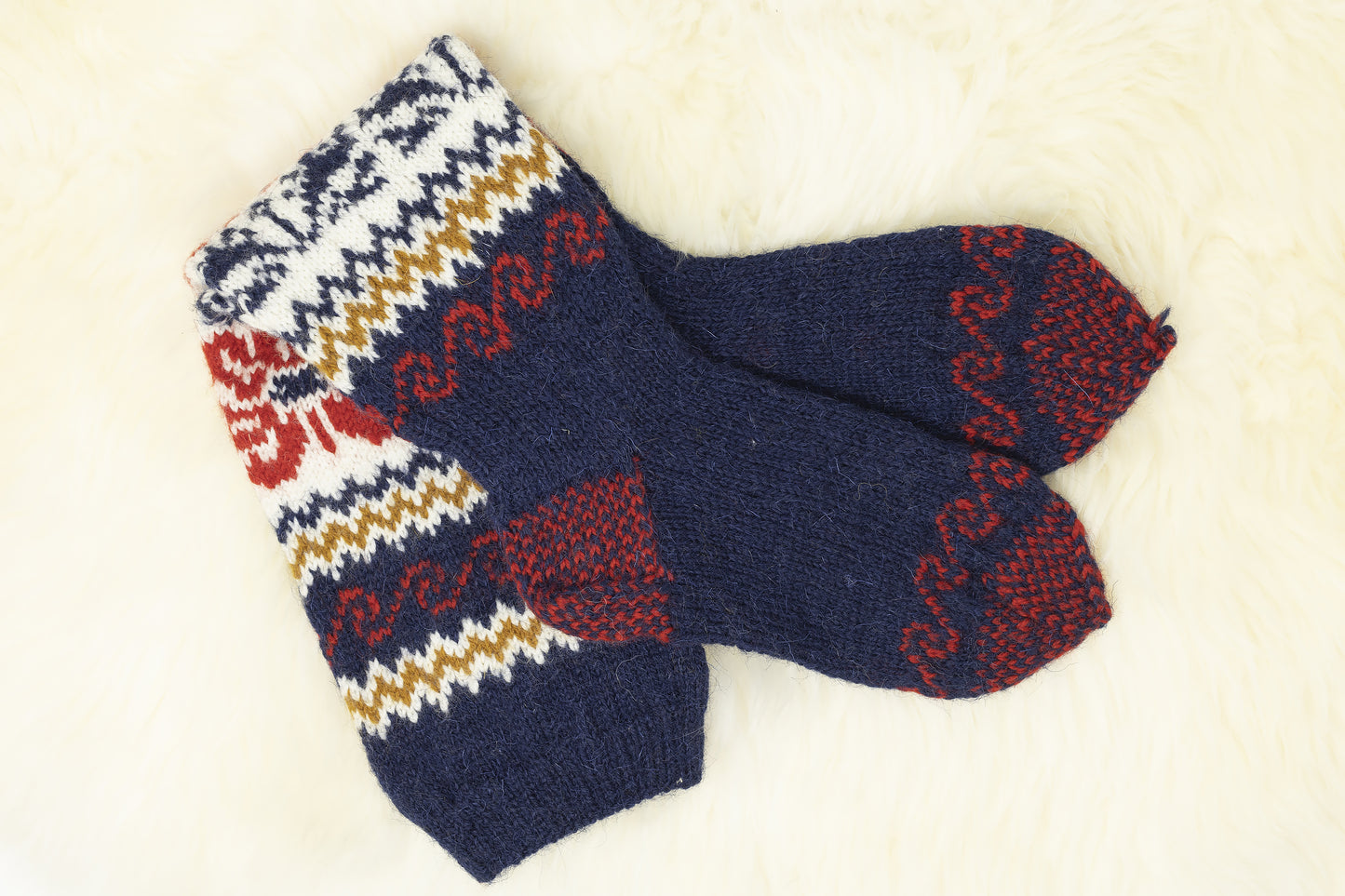 Reinforced heel and sole of floral Estonian hand-knitted knee-high socks in blue, red and white