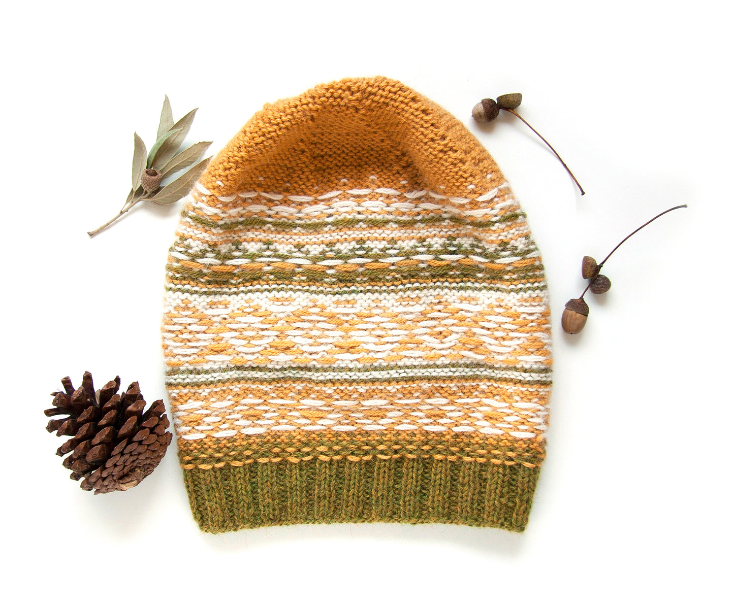 Fair Isle hand-knitted alpaca hat in yellow, white, and green displayed inside out