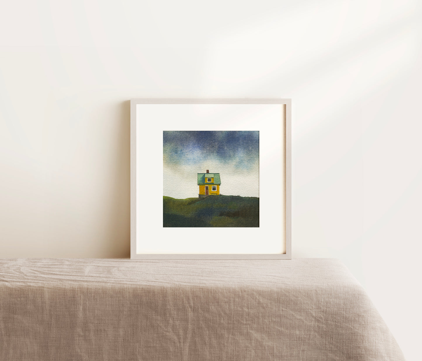 Framed watercolor painting of a small colourfull house on the small car-free Flatey island in the Breiðafjörður fjord, beneath a dramatic Icelandic sky