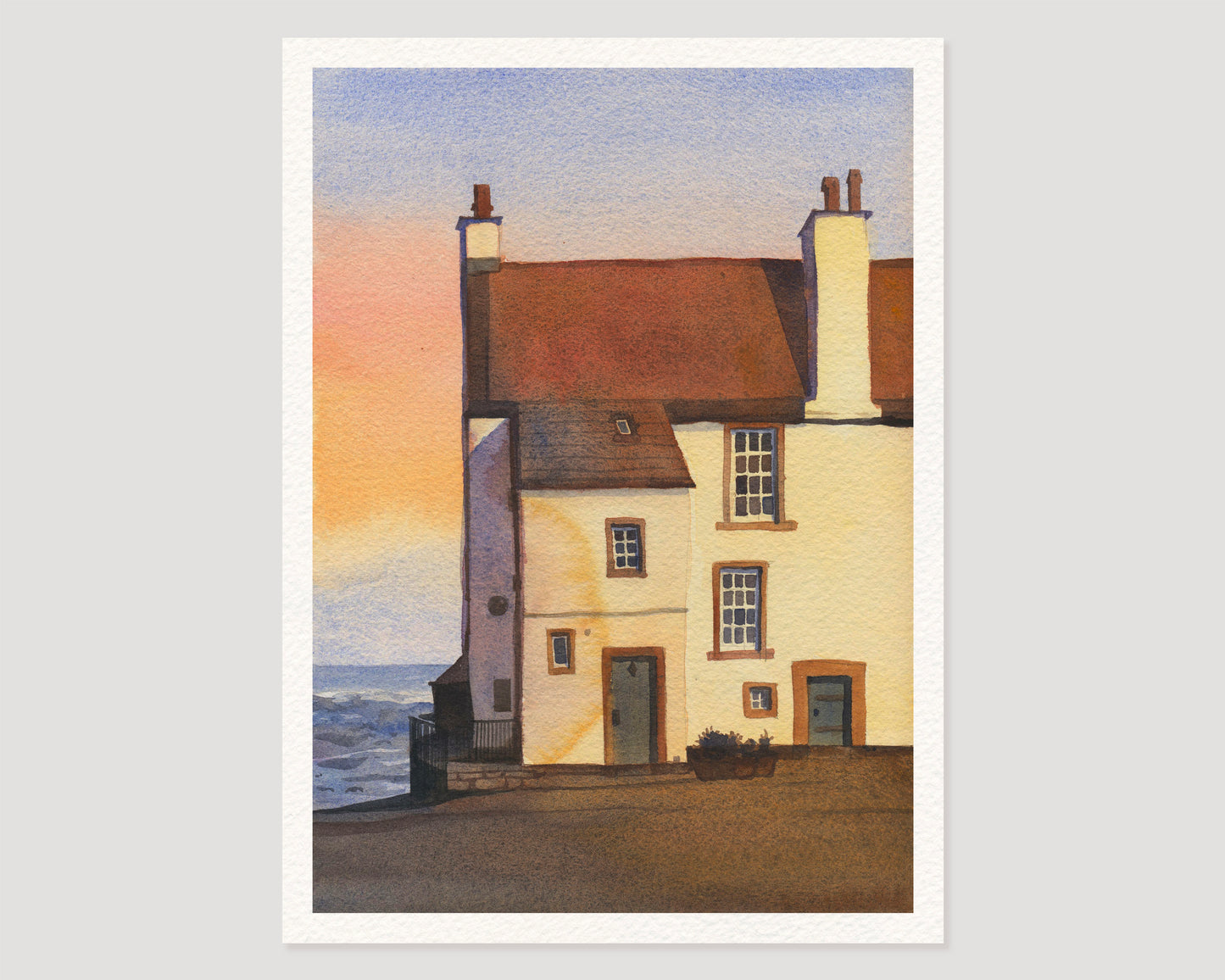 A watercolor art print features Glynes House, the coastal cottage in Pittenweem, a picturesque fishing village on Scotland's East Neuk of Fife coast, with its reddish-brown roof, cream walls, chimneys, and a pale sky with a soft sunset glow.