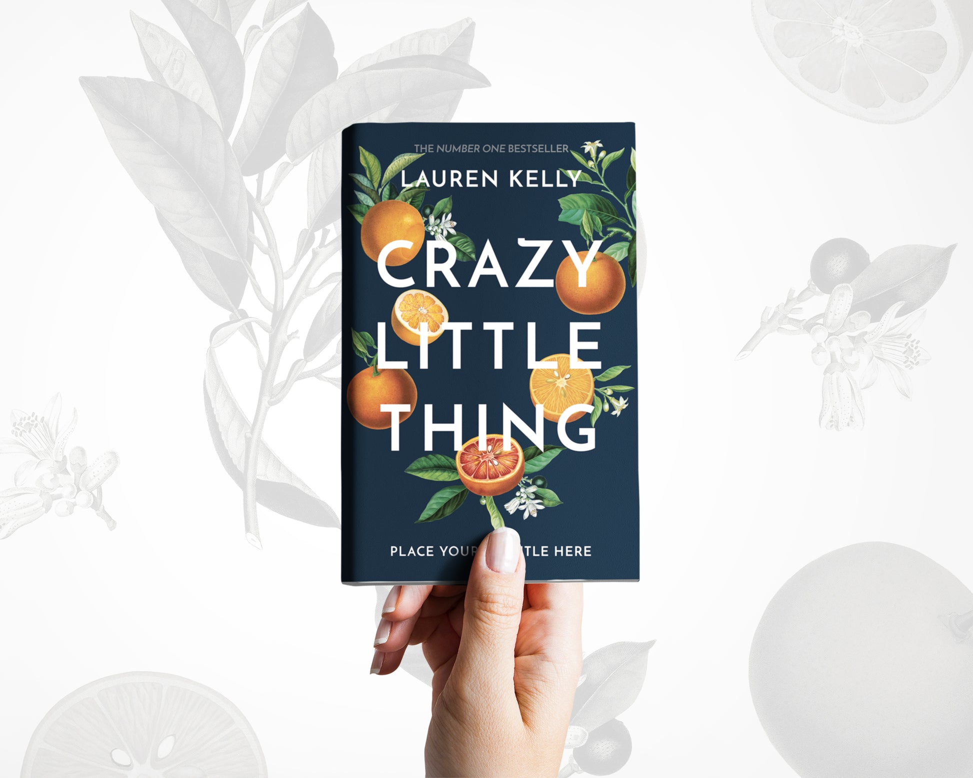 A hand holds a book with vintage botanical oranges illustrations on a black background on its cover.