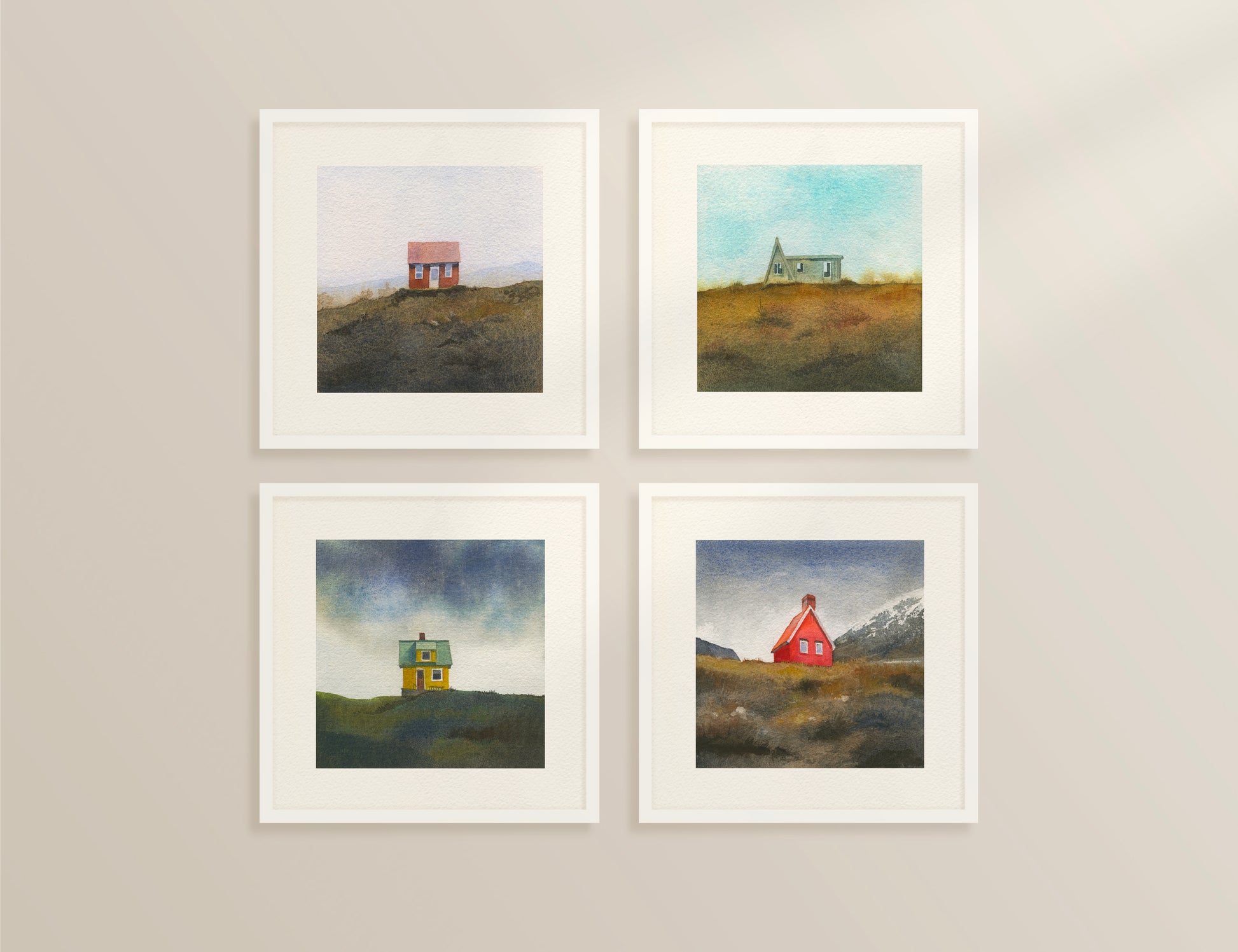Four framed watercolor Icelandic landscapes — an A-frame cabin in the Westfjords, a red cottage in the Icelandic hills, a red cabin near Egilsstaðir in East Iceland, and a colourful house on Flatey Island.