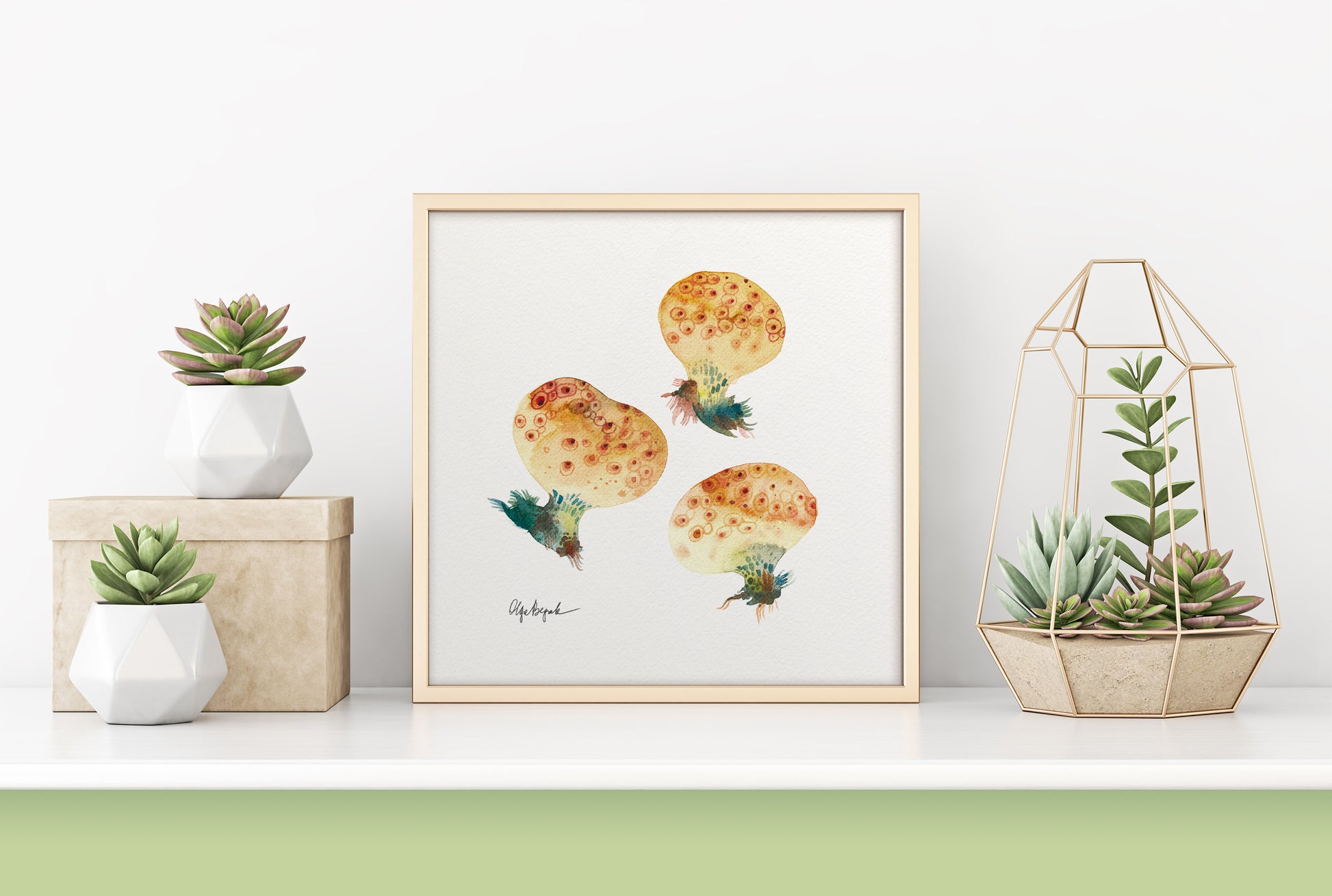 A framed botanical print featuring watercolor study of three mushrooms