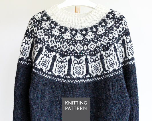 A black and white knitted sweater with Nattuggla Nigh Owl pattern, shown hanging on a white hanger against a white background. A dark gray label at the bottom reads 'KNITTING PATTERN'.