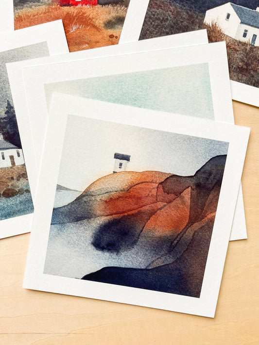 Collection of small watercolor paintings featured nordic nature on a wooden surface