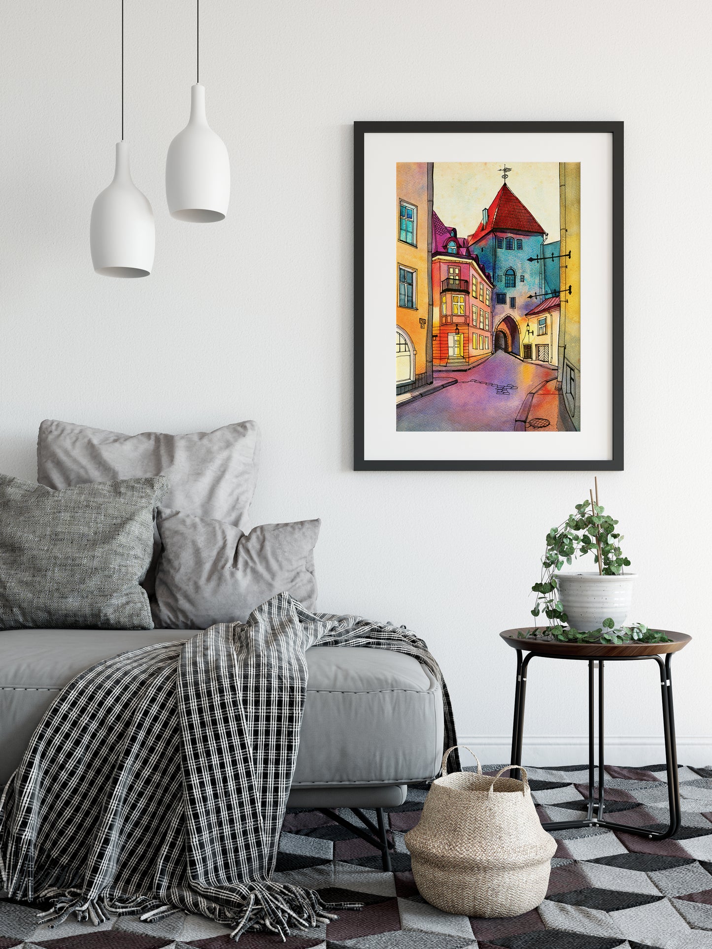 Large framed art print featuring Pikk street in Old Tallinn, Estonia, hung on a white wall above a gray sofa in a modern living room setting.