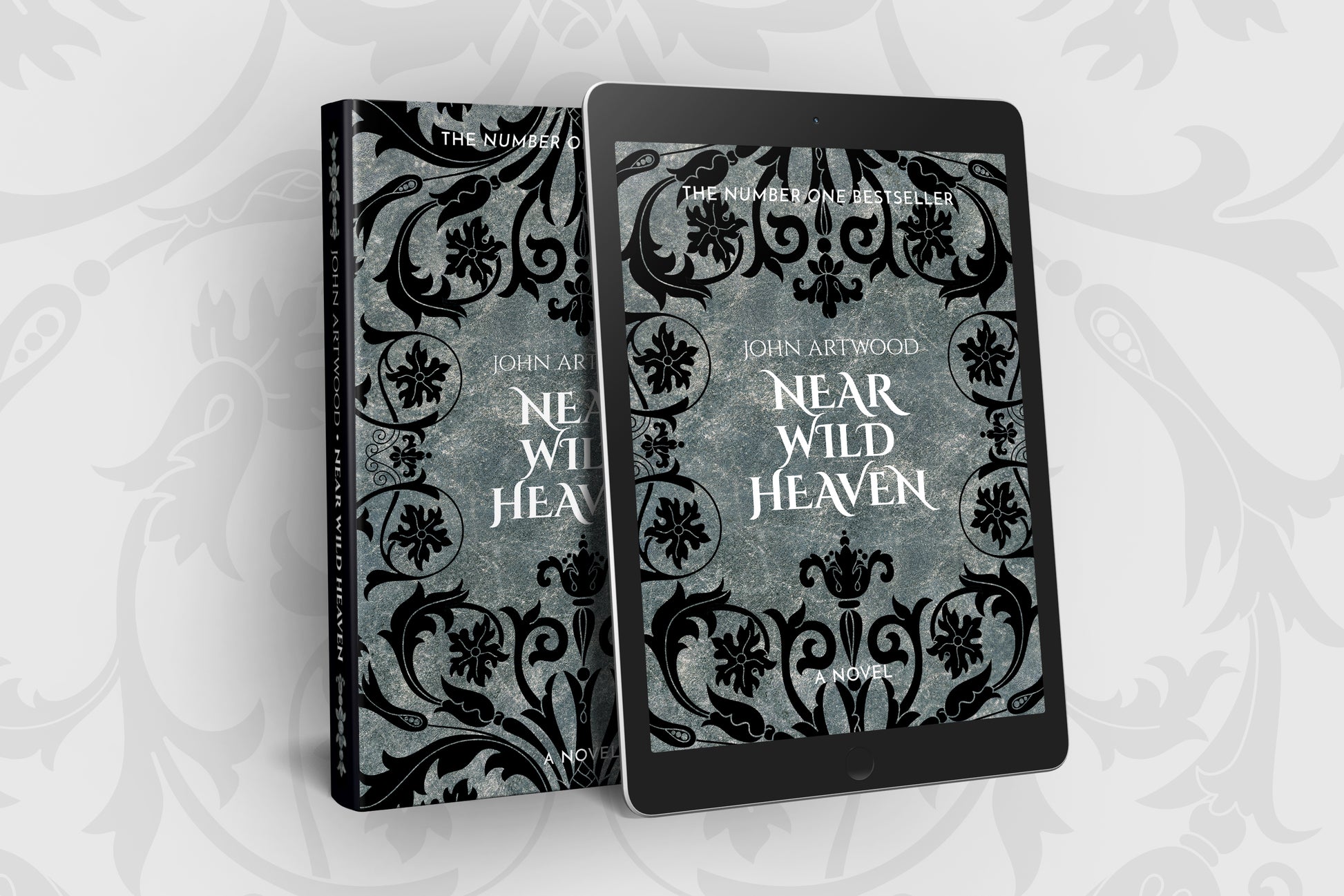 Paperback and tablet with the same book cover with black baroque ornament on a silver background