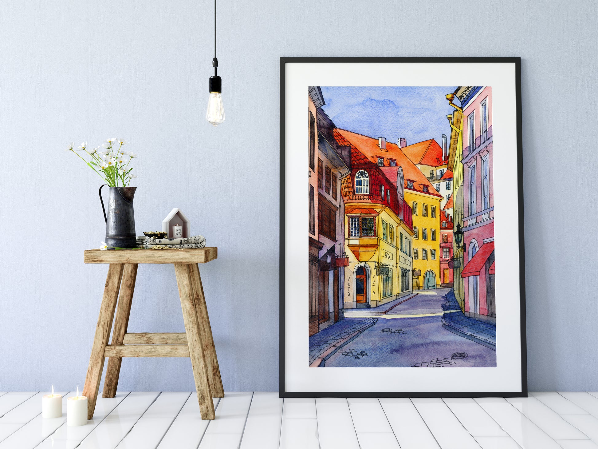 Watercolor and ink artwork of Pikk Street in Tallinn with colorful facades and the Veta shopfront, displayed in a black frame