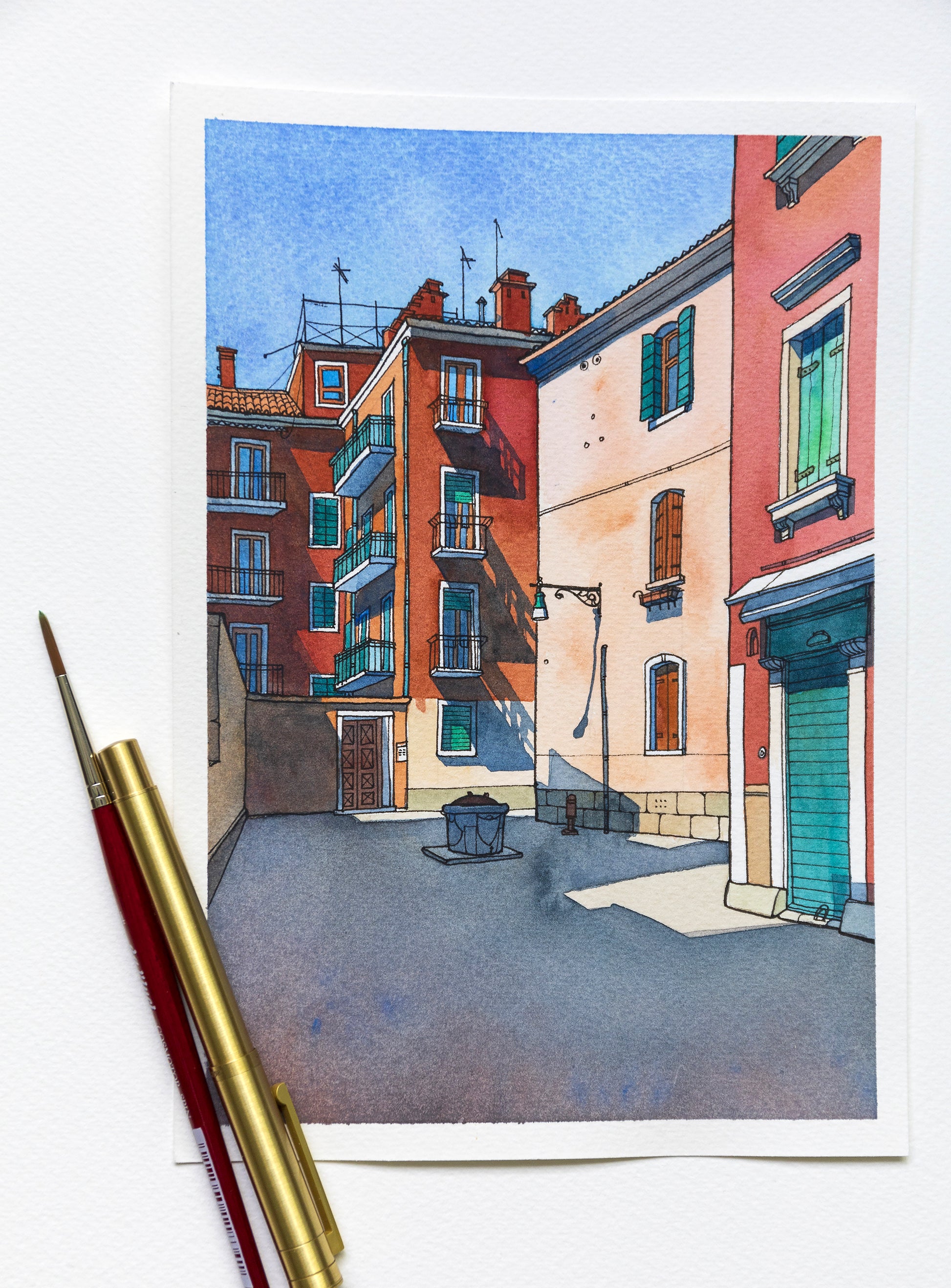 original watercolor and ink painting of Ramo de le Muneghe in Venice, Italy, accompanied by art supplies