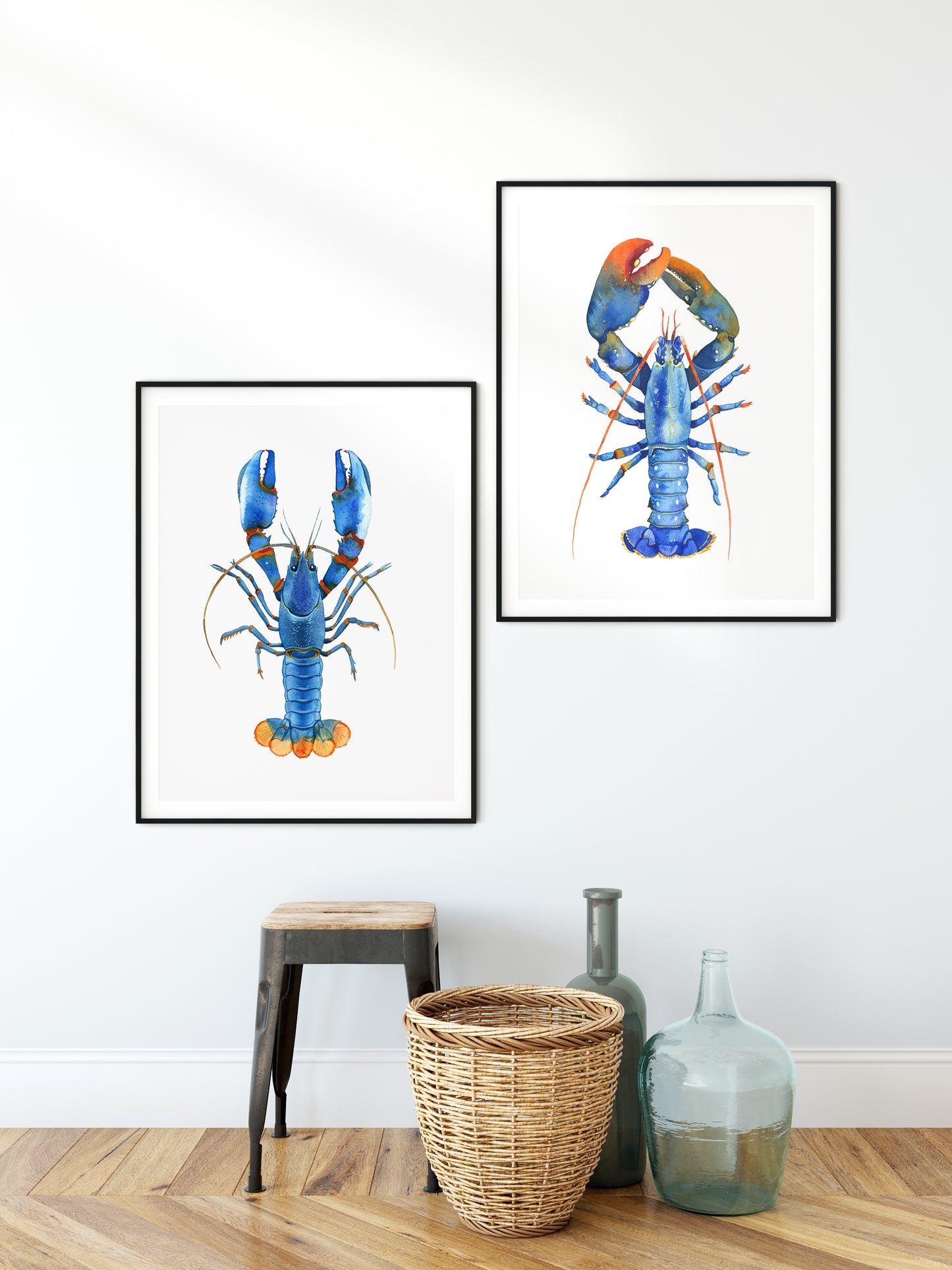 Set of two blue lobster watercolor art prints in black frames.