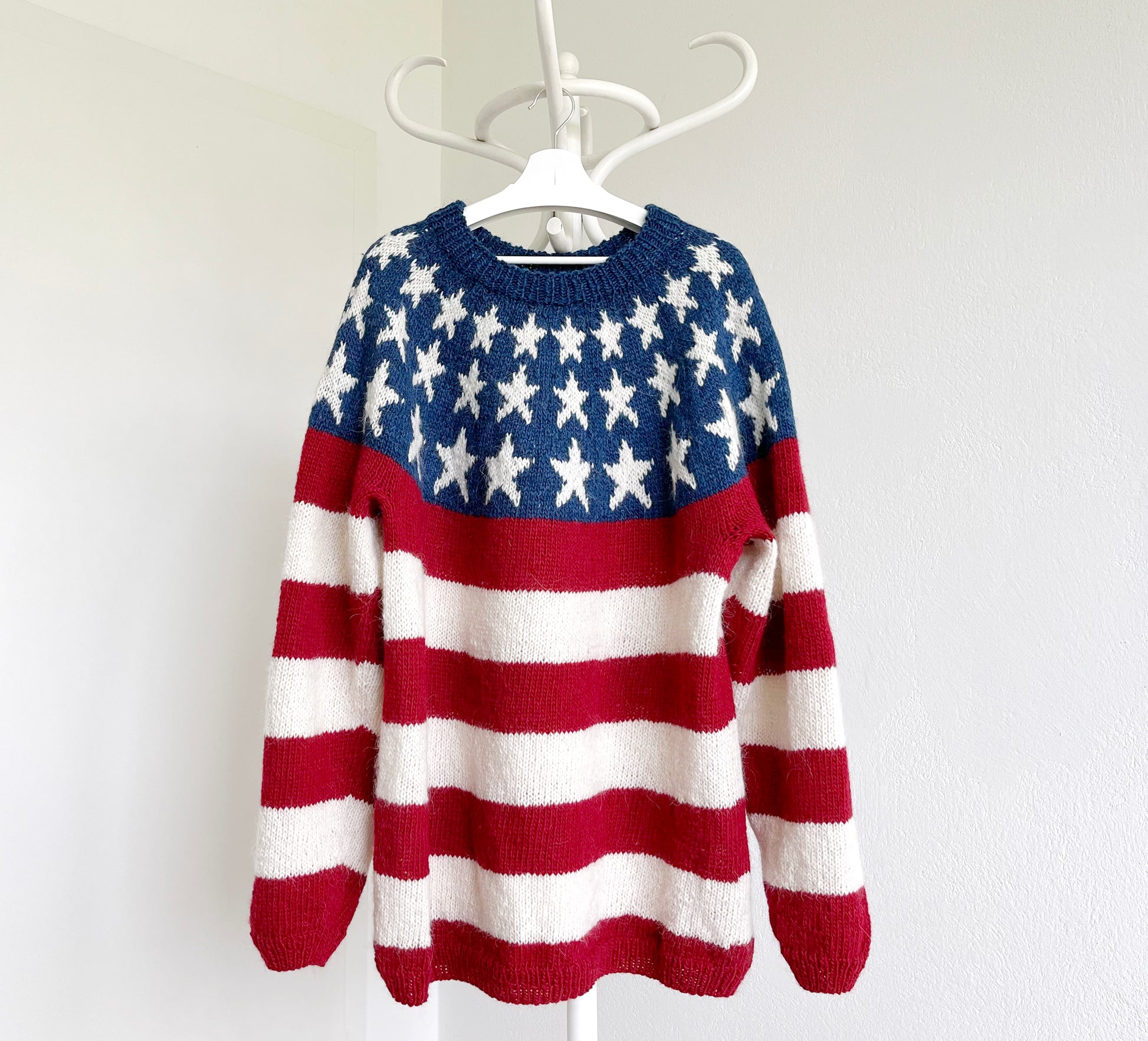 View of hand-knitted lopapeysa sweater in the USA Fflag stars and stripes design