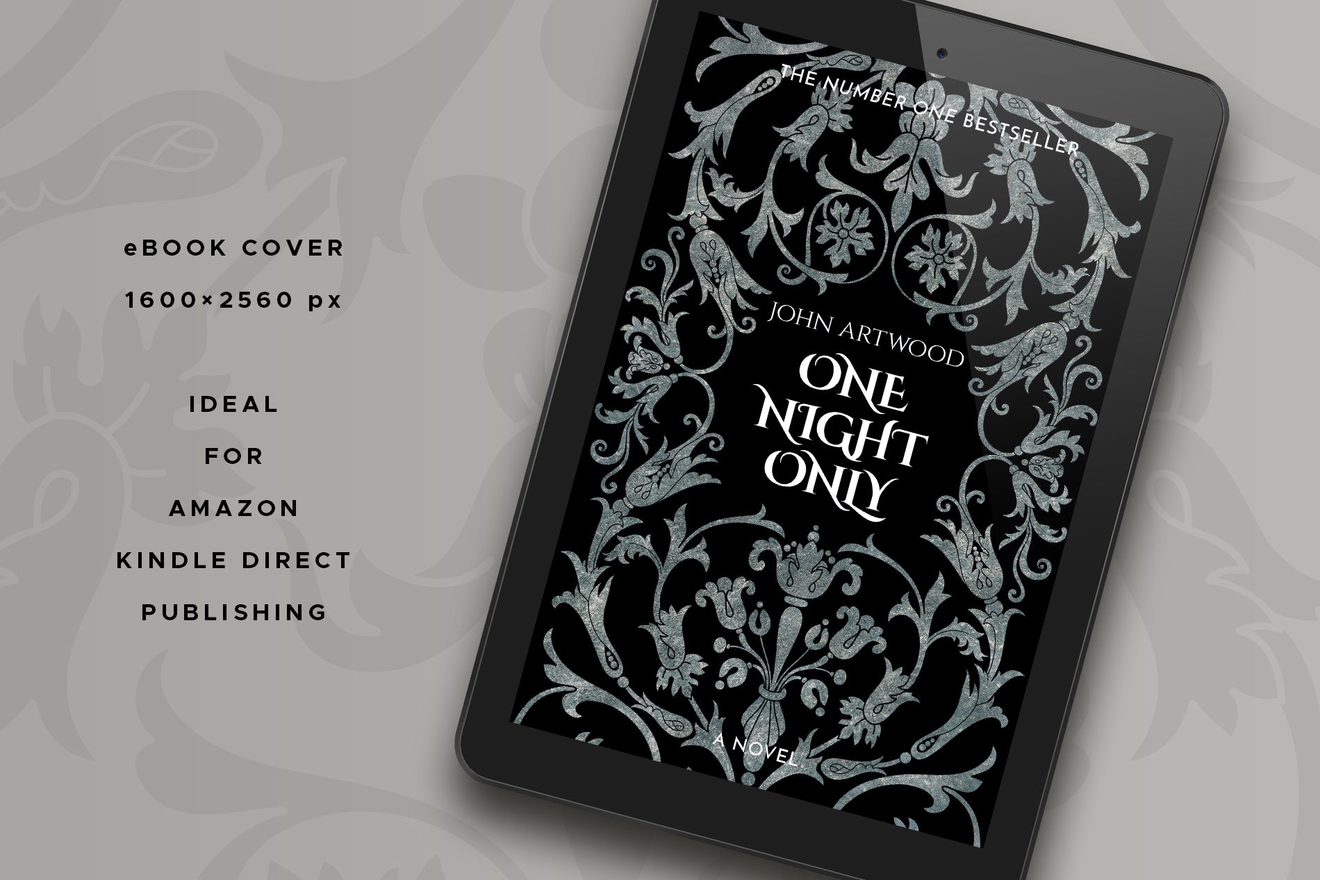 A tablet with a book cover featuring silver baroque ornament on a black background, displayed on a gray surface.