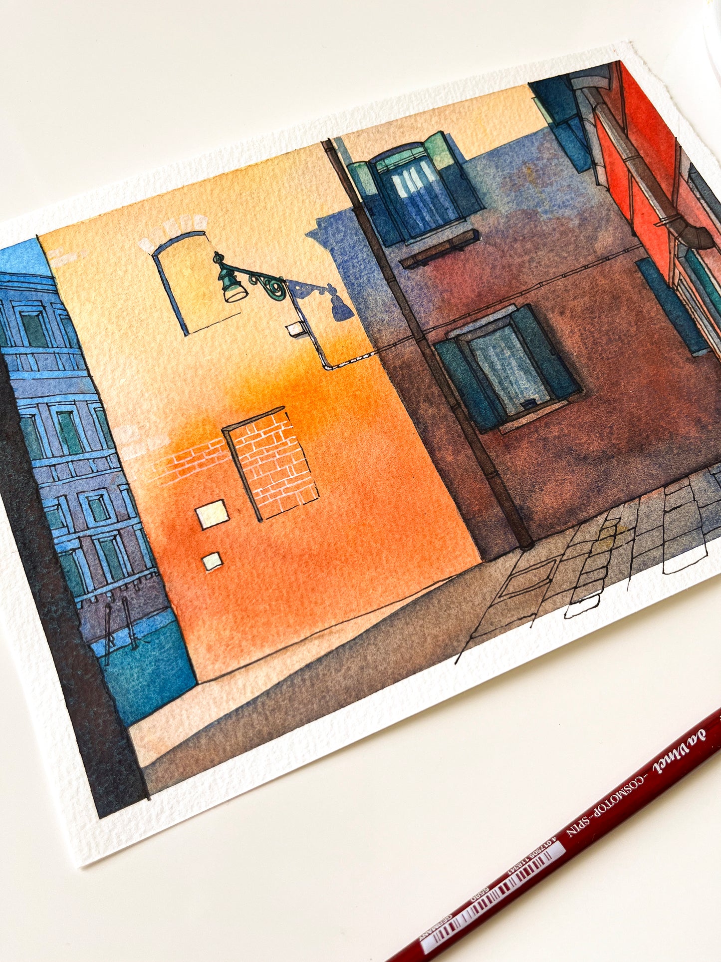 Venice canal street original watercolor and ink artwork with a paintbrush on a white background