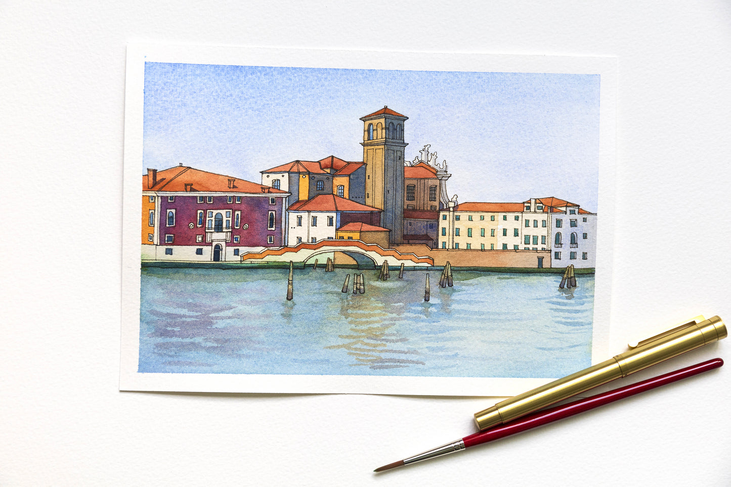 Original watercolor and ink artwork of Venetian Fondamenta Nova, accompanied by painting tools.