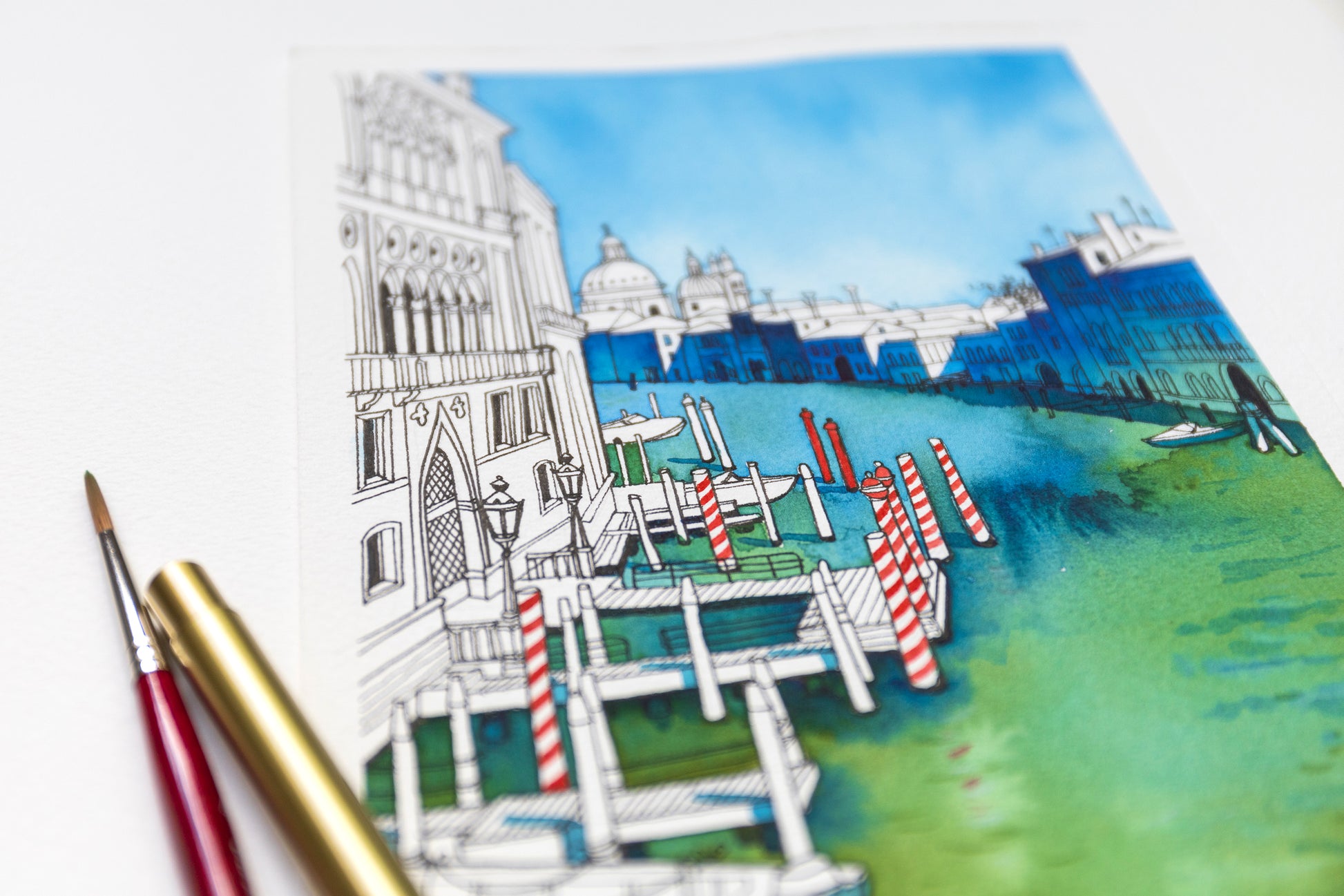Close-up of an original Ink and watercolor illustration of Venetian Grand canal viewed from the Accademia Bridge, accompanied by paintbrush and pen